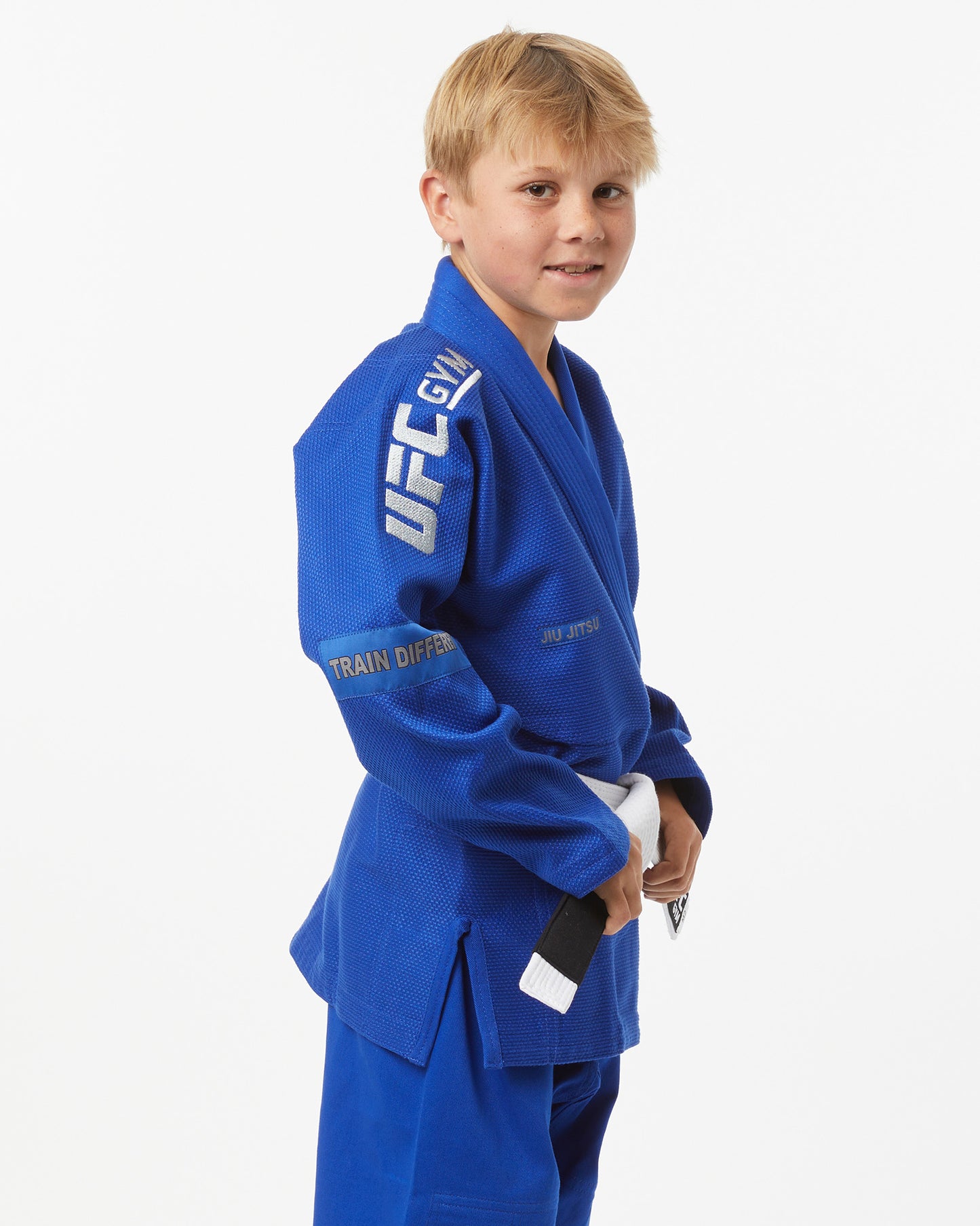 Child wearing a blue UFC Gi on a white background facing right looking forward