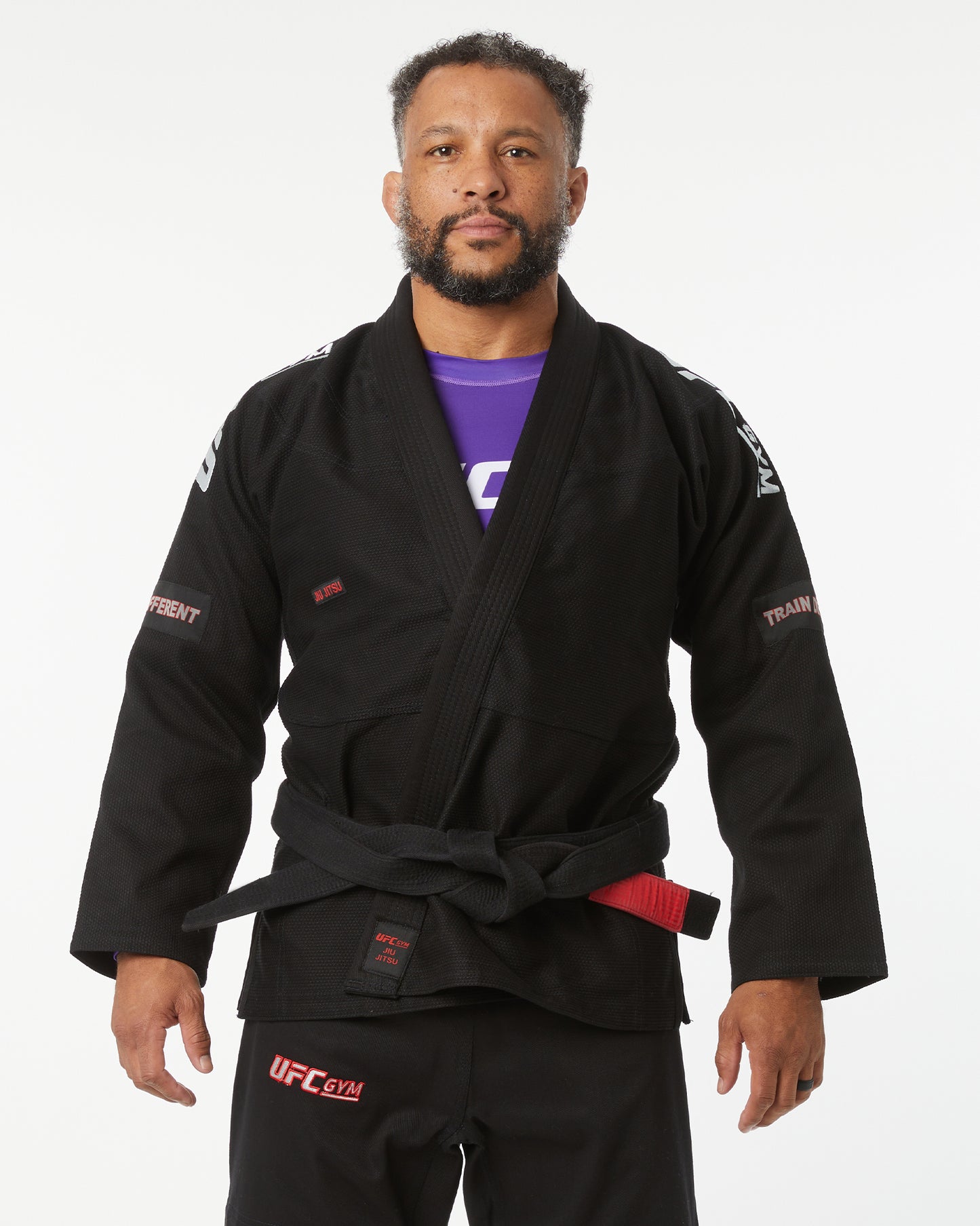 Man wearing a black UFC gym gi on a white background hands down