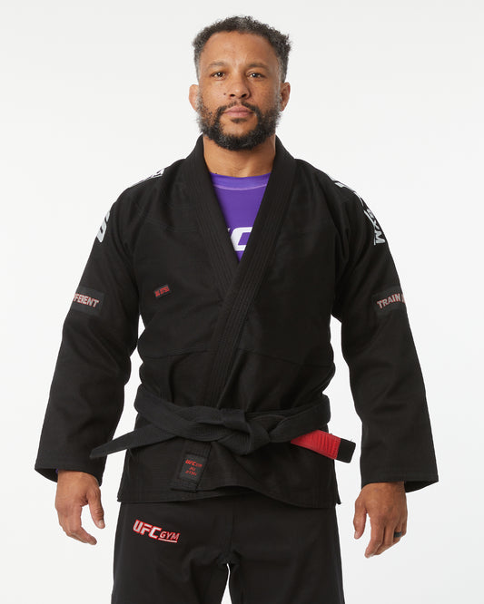 Man wearing a black UFC gym gi on a white background hands down