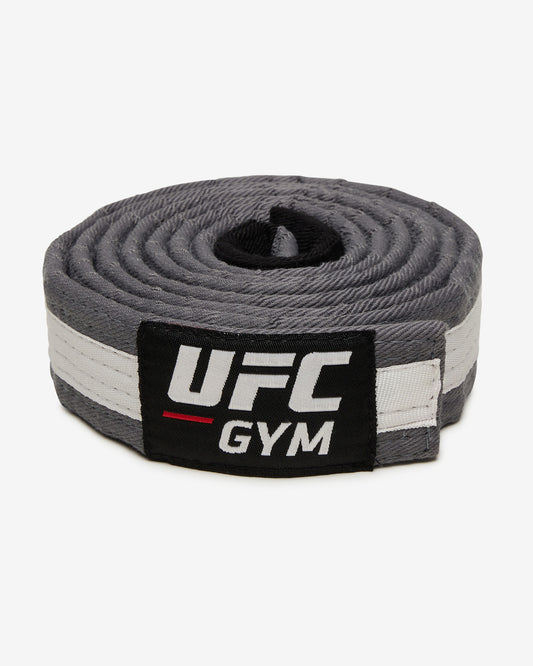 Gray UFC Gym belt with a white stripe on a white background facing forward