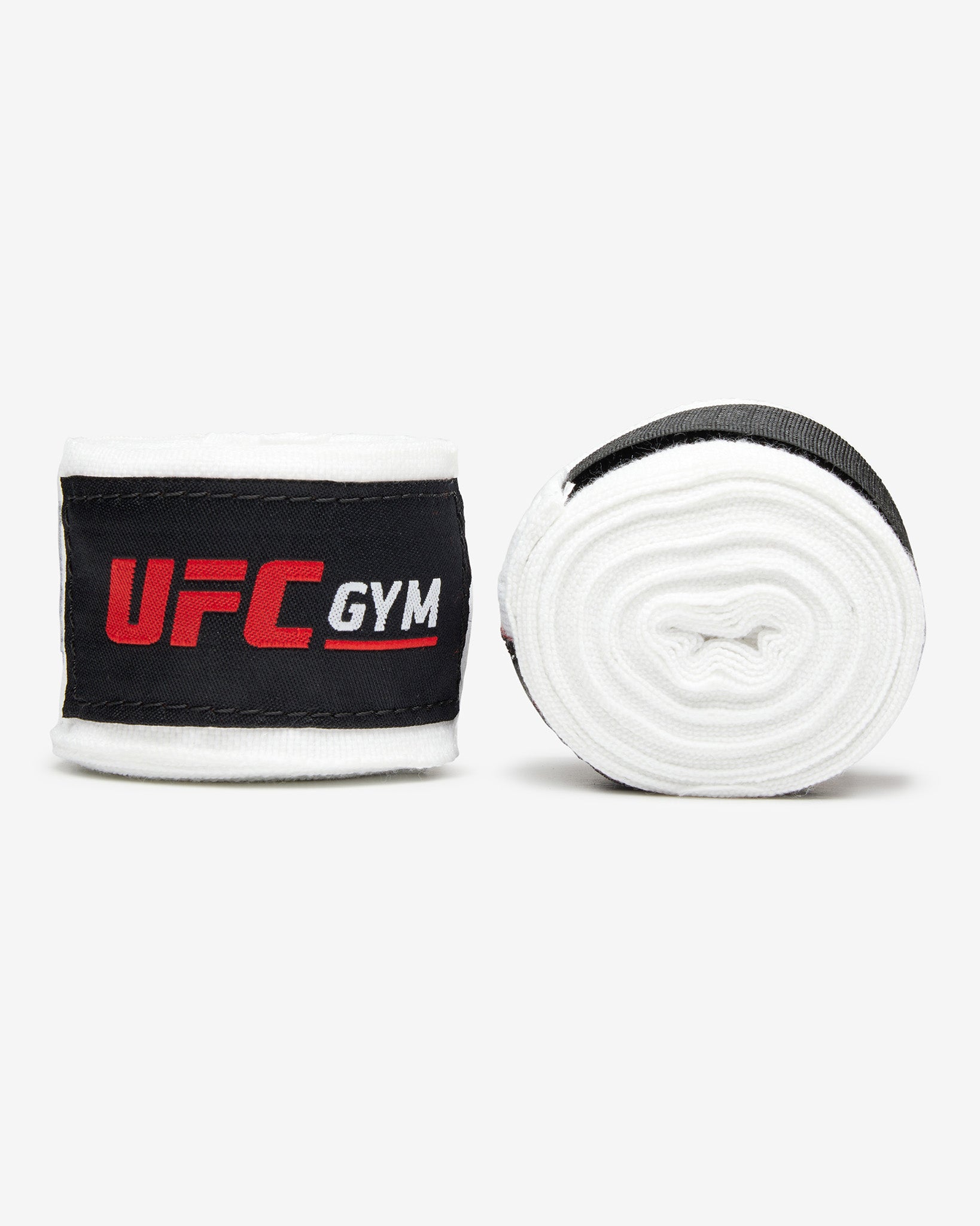 The TD 180 HAND WRAPS WHITE by UFC Gym feature black velcro straps and red-and-white UFC Gym logos, shown flat on a white background—ideal for mixed martial arts fighters.