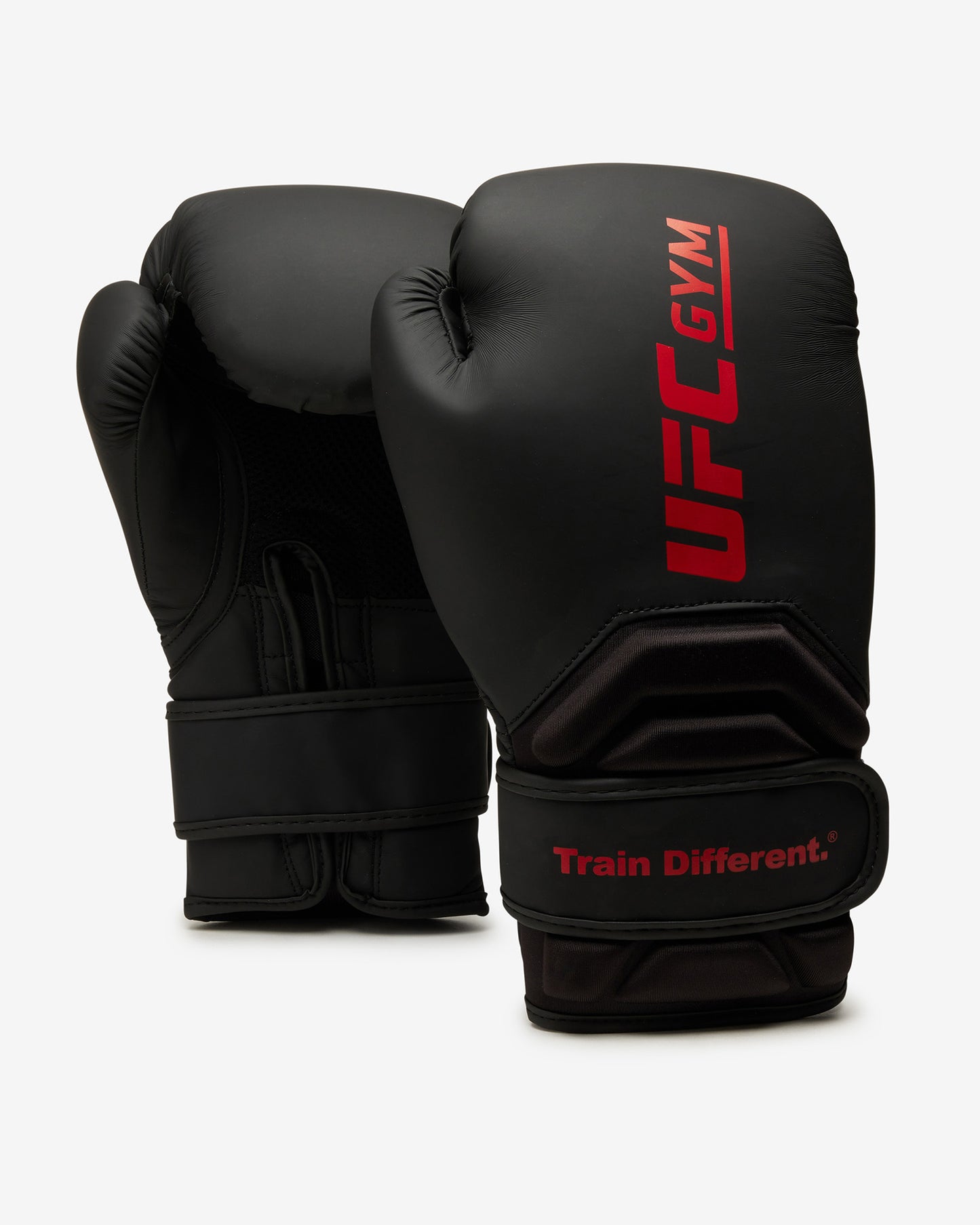 Two black TD ADULT BOXING GLOVE BLACK by UFC Gym stand upright on a white background. One glove features the red UFC Gym logo and Train Different. slogan; the other shows the palm, wrist straps, and protective design.