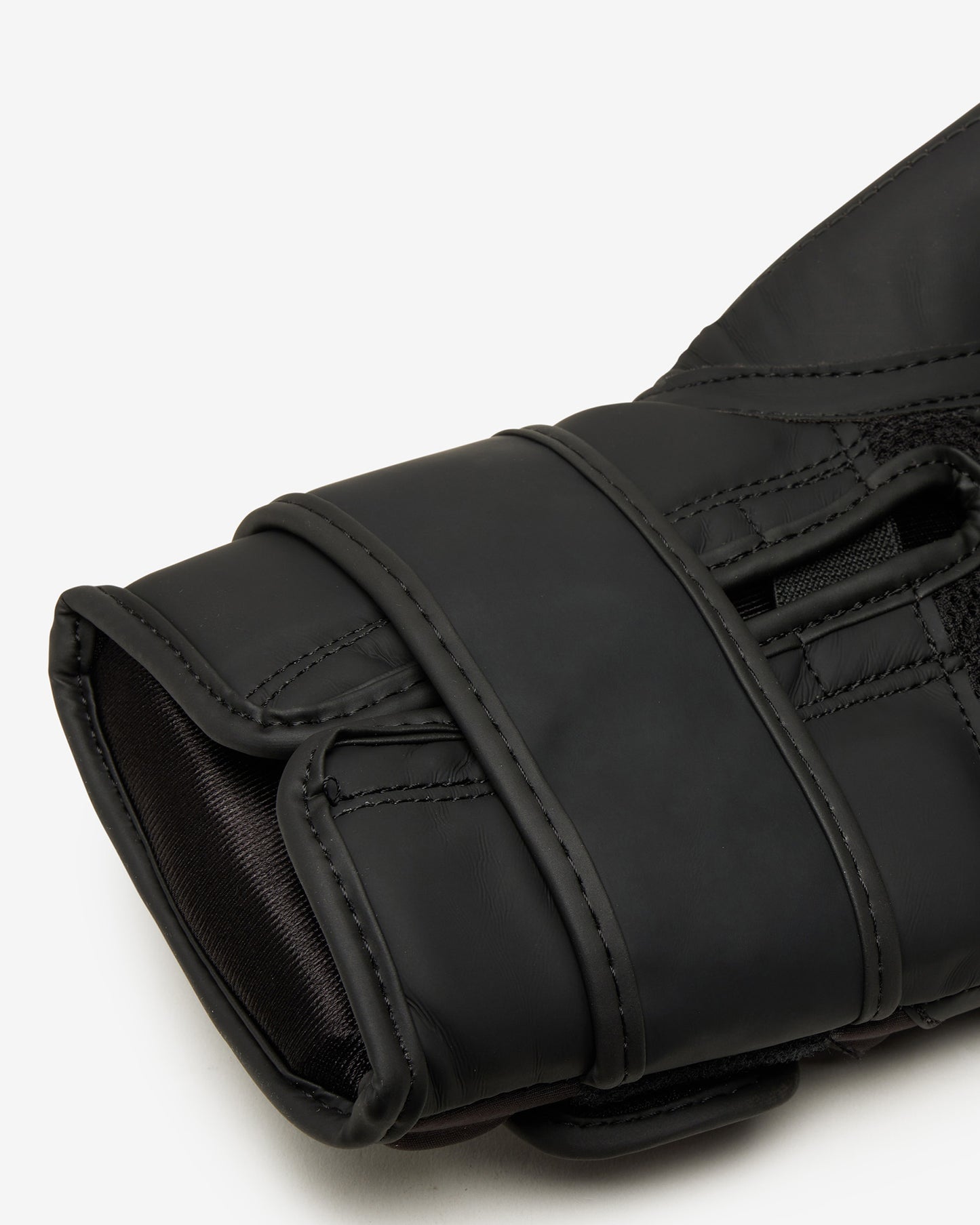 Close-up of a black glove on a white background