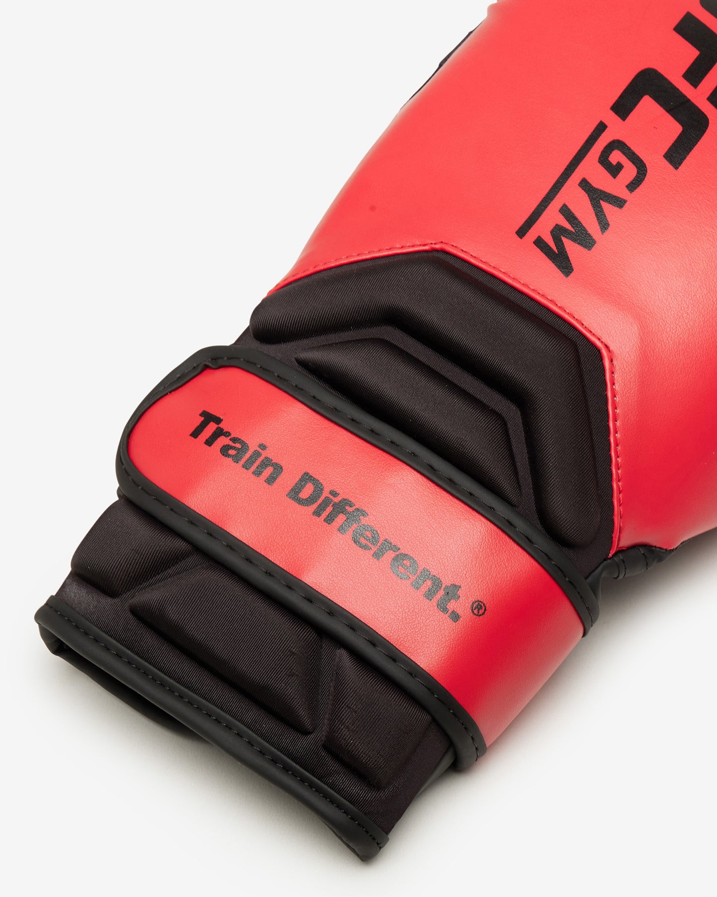Red boxing glove with black accents and 'Train Different' text on a white background