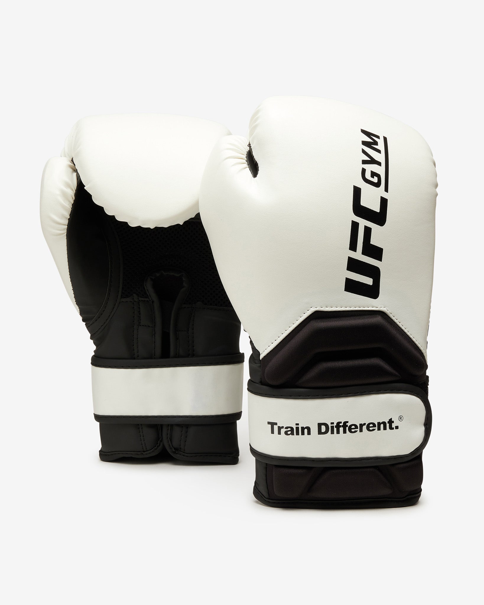 The UFC Gym TD Adult Boxing Glove White is displayed against a white background, featuring the UFC Gym logo on one glove and the Train Different. slogan on the wrist strap for extra protection.