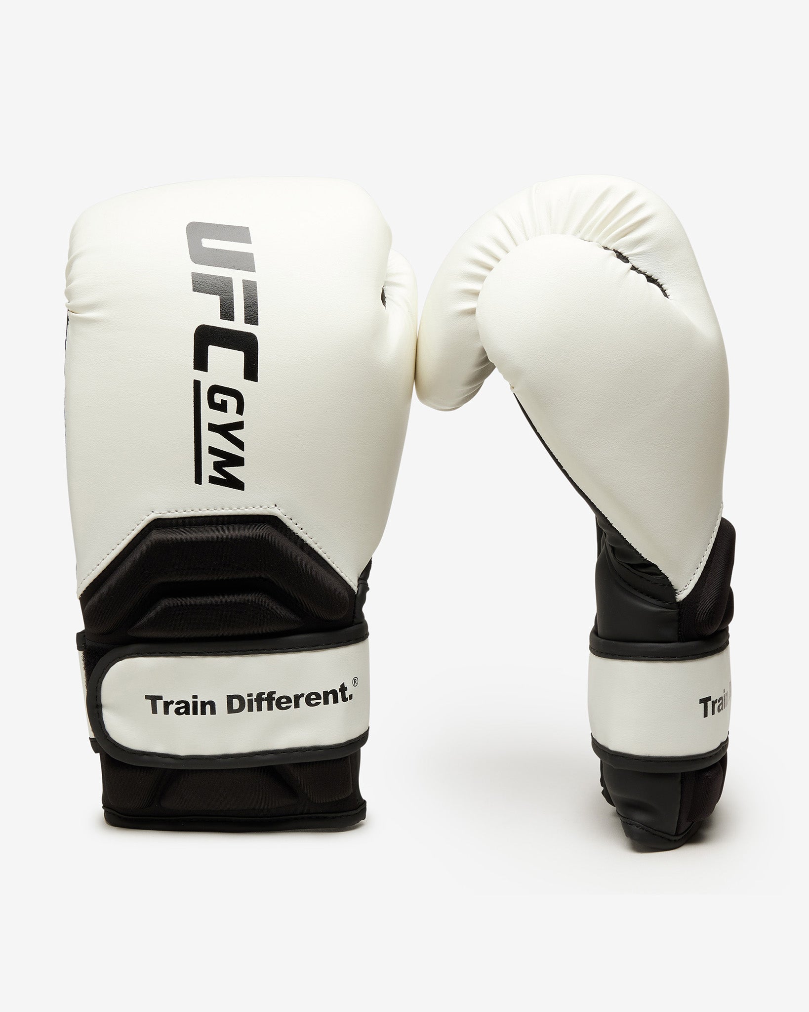 The UFC Gym TD Adult Boxing Glove White is displayed against a white background, featuring the UFC Gym logo on one glove and the Train Different. slogan on the wrist strap for extra protection.