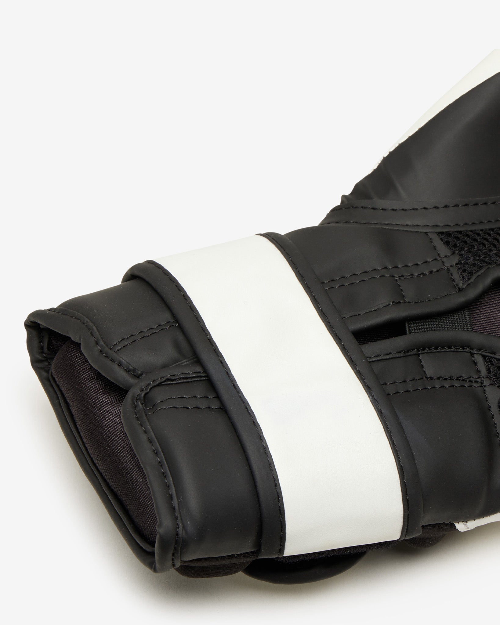 Black and white boxing glove on a light gray background