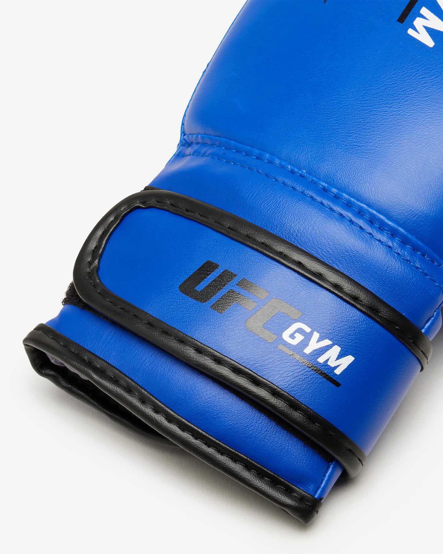 The TD YOUTH BOXING GLOVE BLUE by UFC Gym, designed for youth training, features blue gloves with black accents. Displayed on a white background