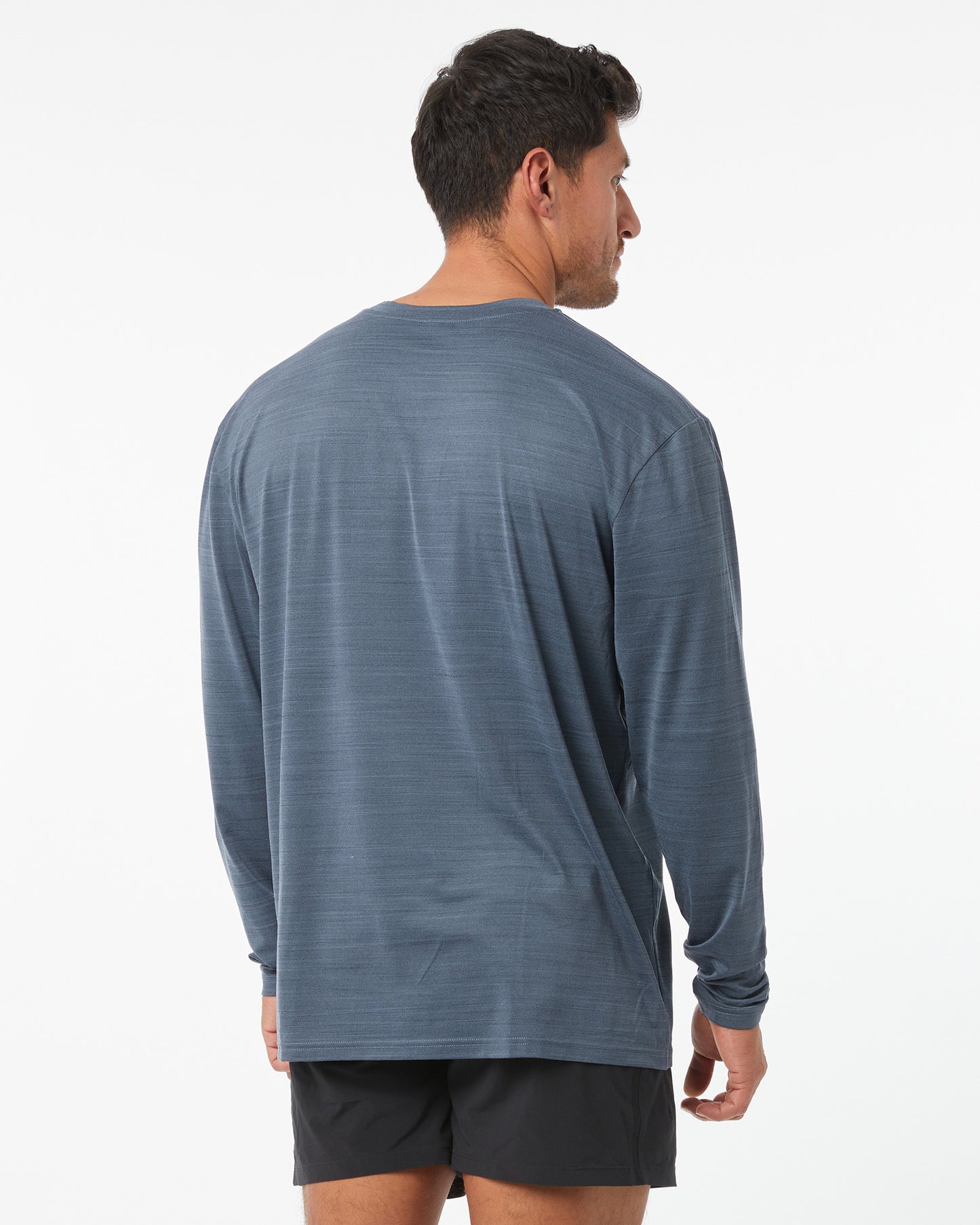 Man wearing a blue long-sleeve shirt on a white background