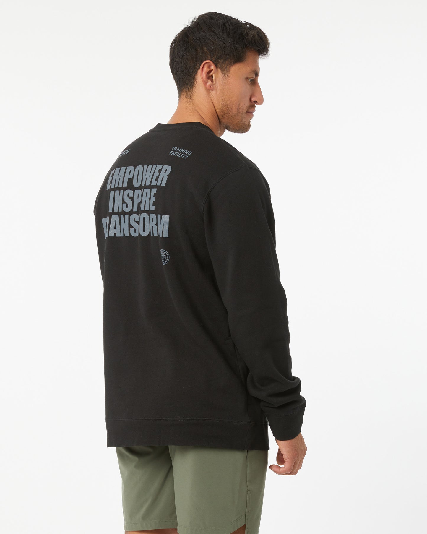 Man wearing a black sweatshirt with text on the back, standing against a white background