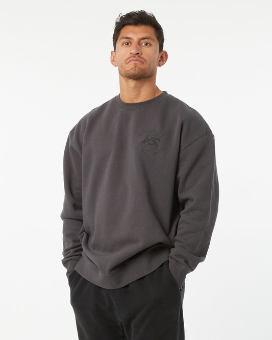Man wearing a dark gray sweatshirt with a logo on a white background