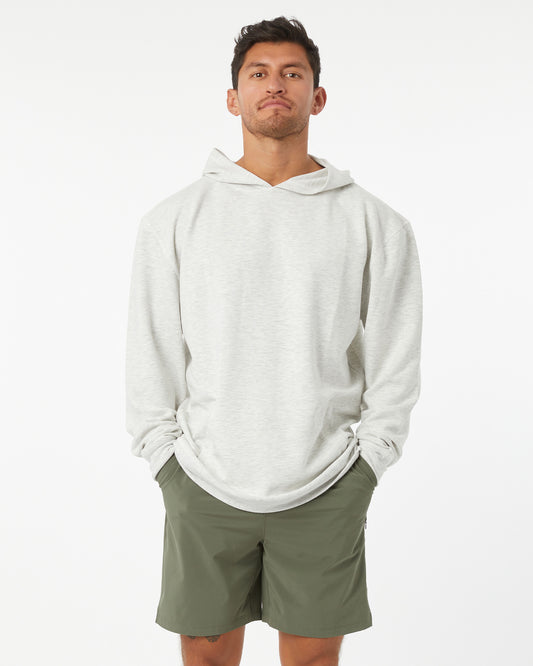 Man wearing a heather grey hoodie and green shorts on a white background