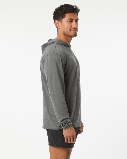 Man wearing a gray hoodie and black shorts on a white background
