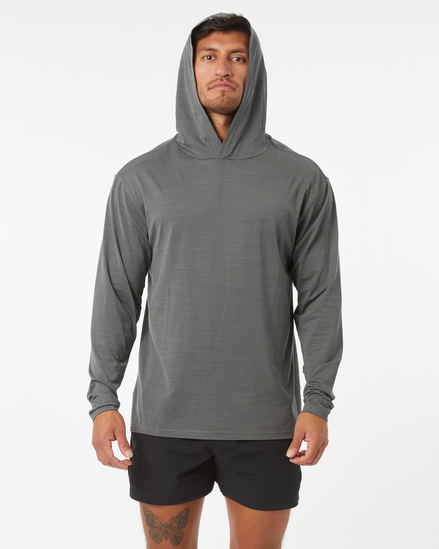 Man wearing a gray hoodie and black shorts on a white background