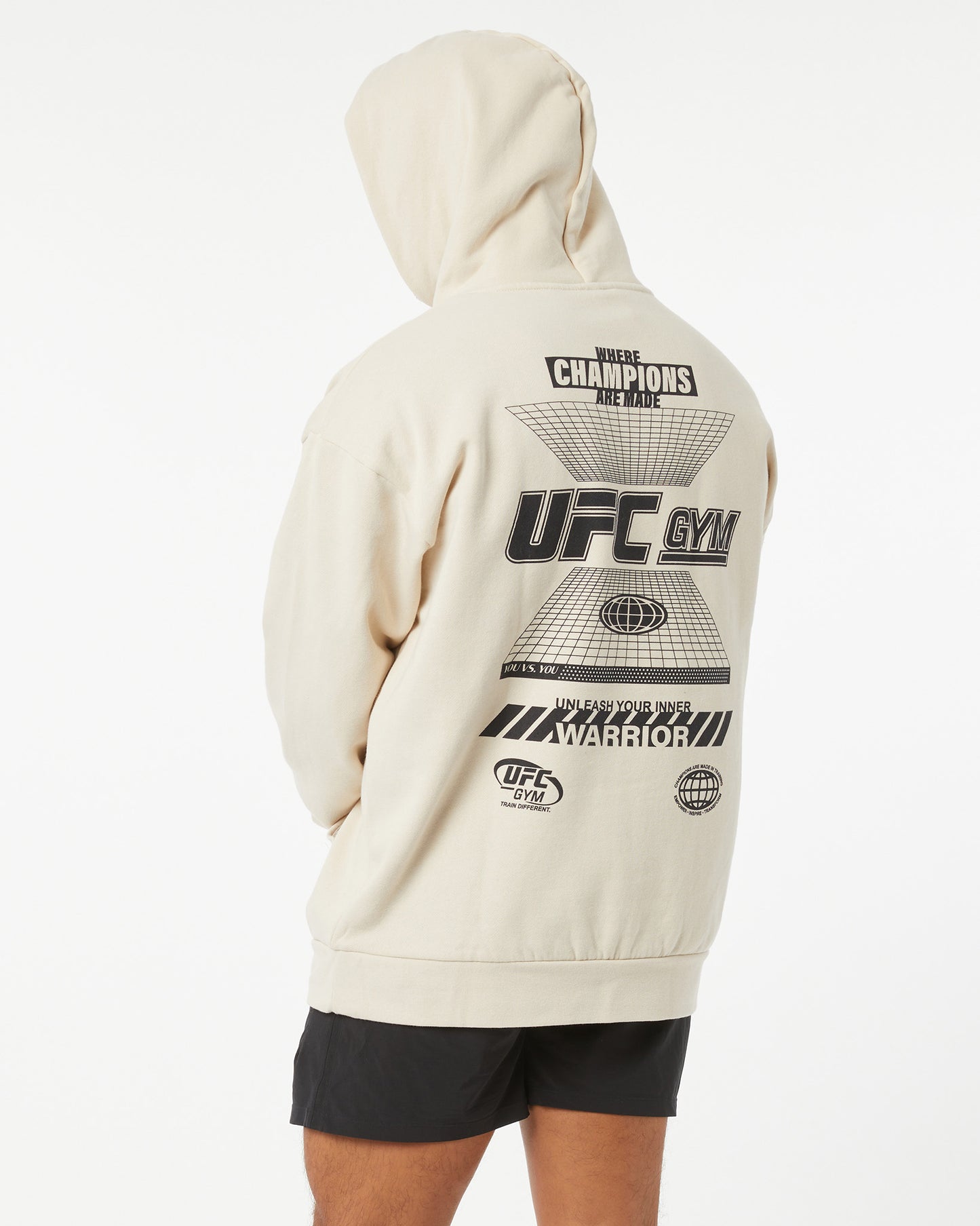 Beige hoodie with UFC Gym branding on the back, worn by a person.