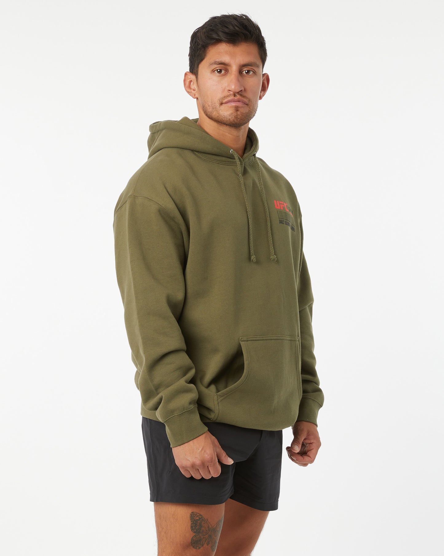 Man wearing an olive green hoodie with a brand logo on a white background