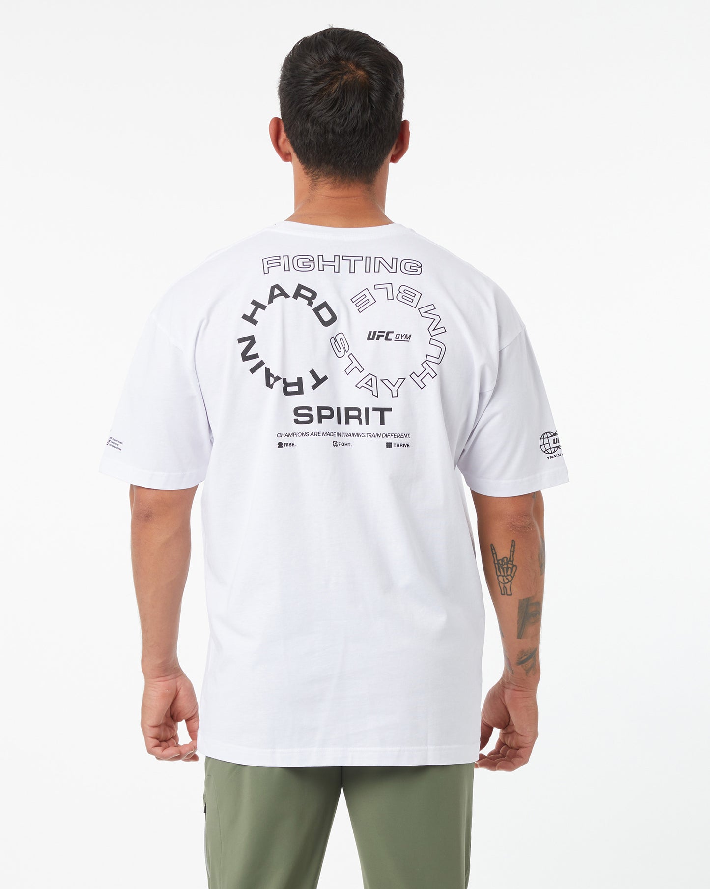 Person wearing a white UFC t-shirt with text on the back against a white background