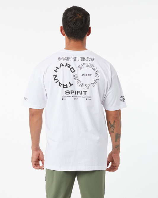 Person wearing a white UFC t-shirt with text on the back against a white background