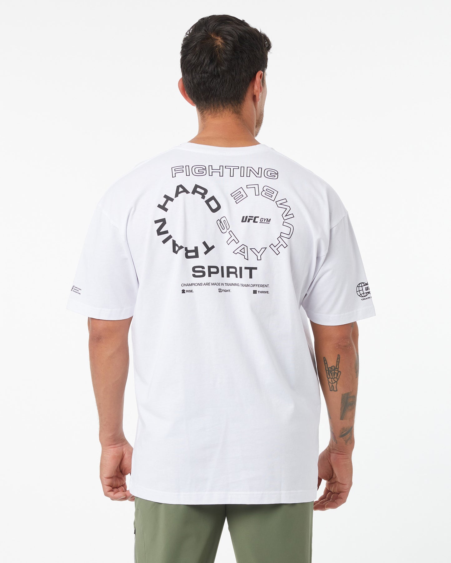 Person wearing a white UFC t-shirt with text on the back against a white background