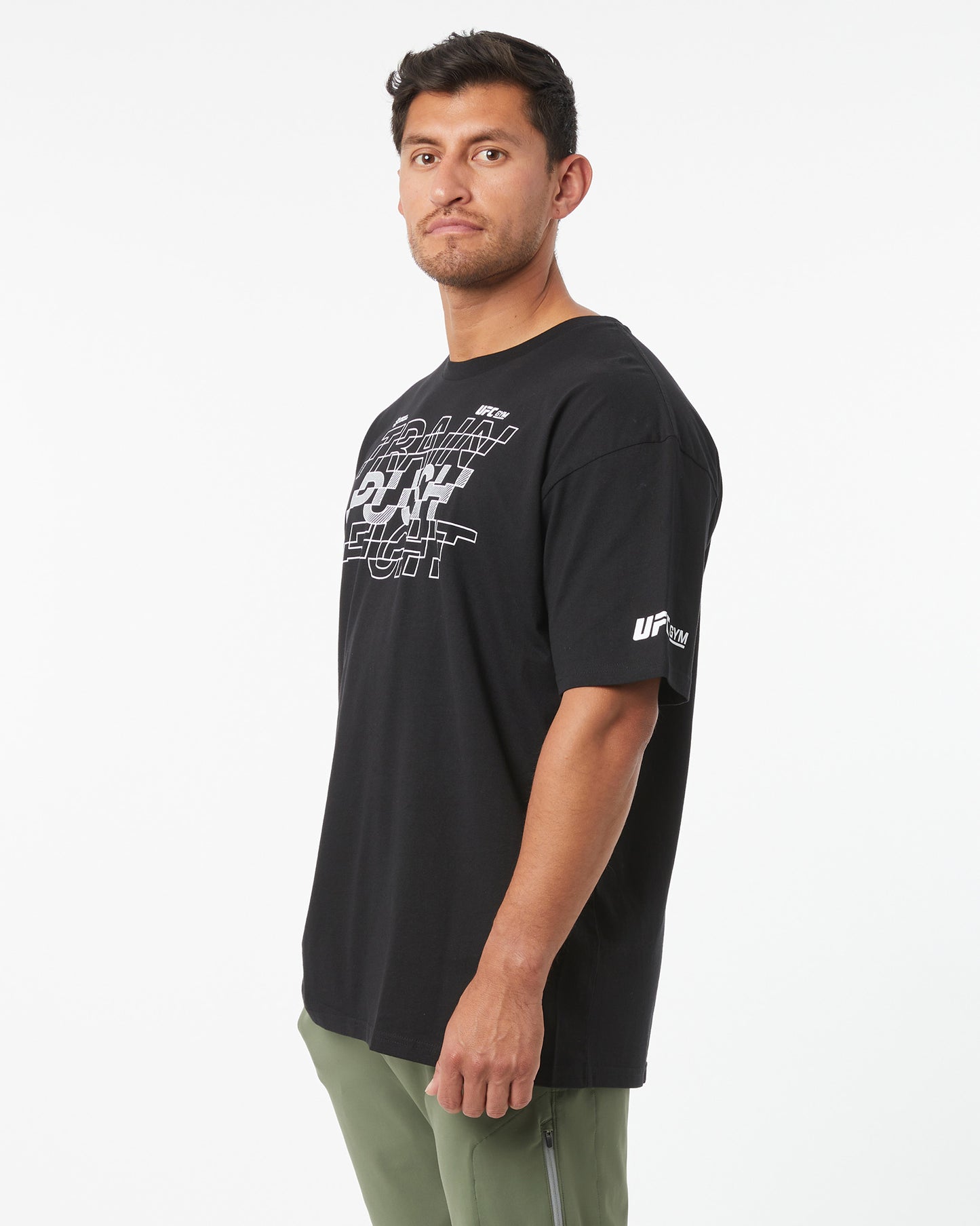 Man wearing a black t-shirt with logos on a white background