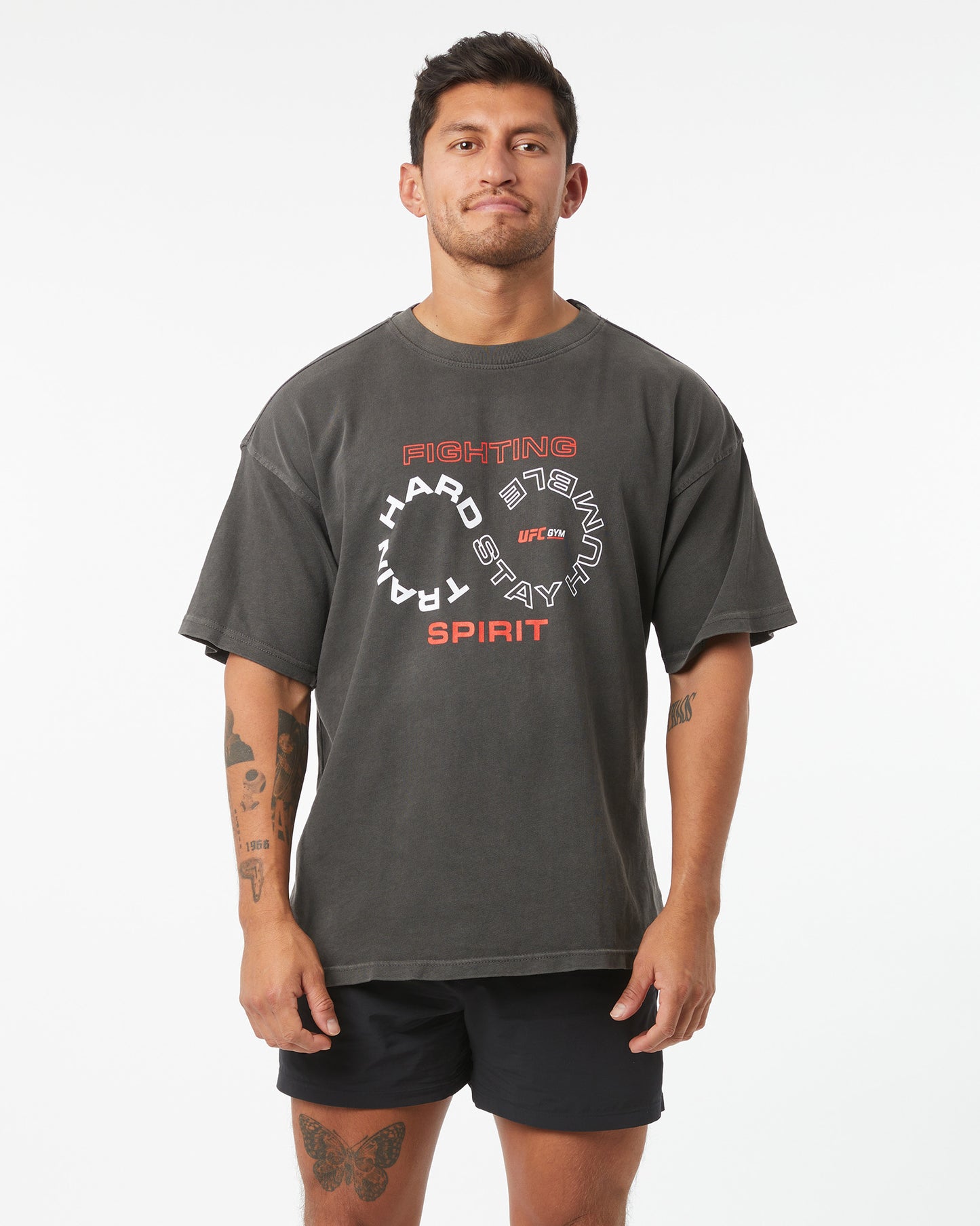 Man wearing a gray t-shirt with red and white text on a white background