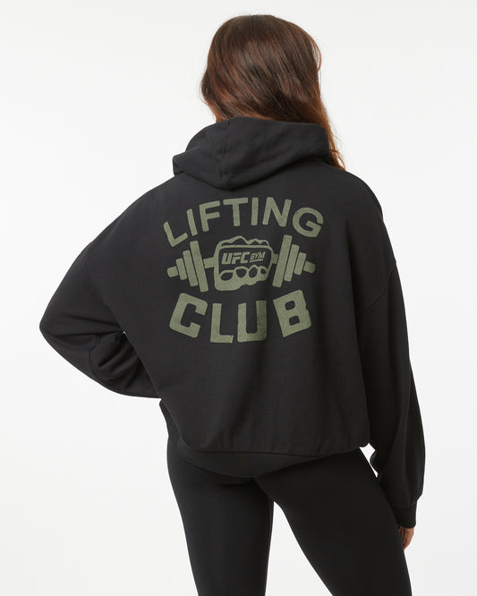 Person wearing a black hoodie with 'Lifting Club' text and UFC logo on the back.
