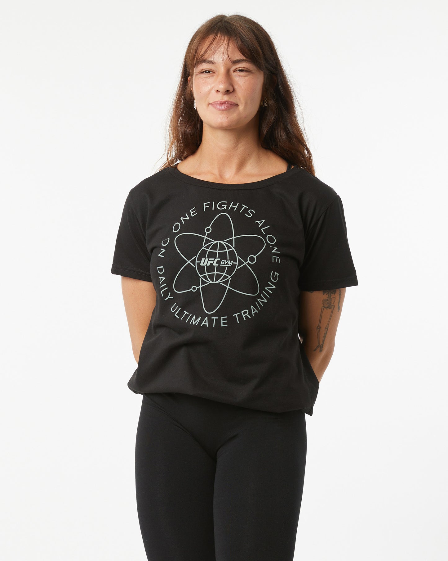 Person wearing a black t-shirt with a graphic design on a white background