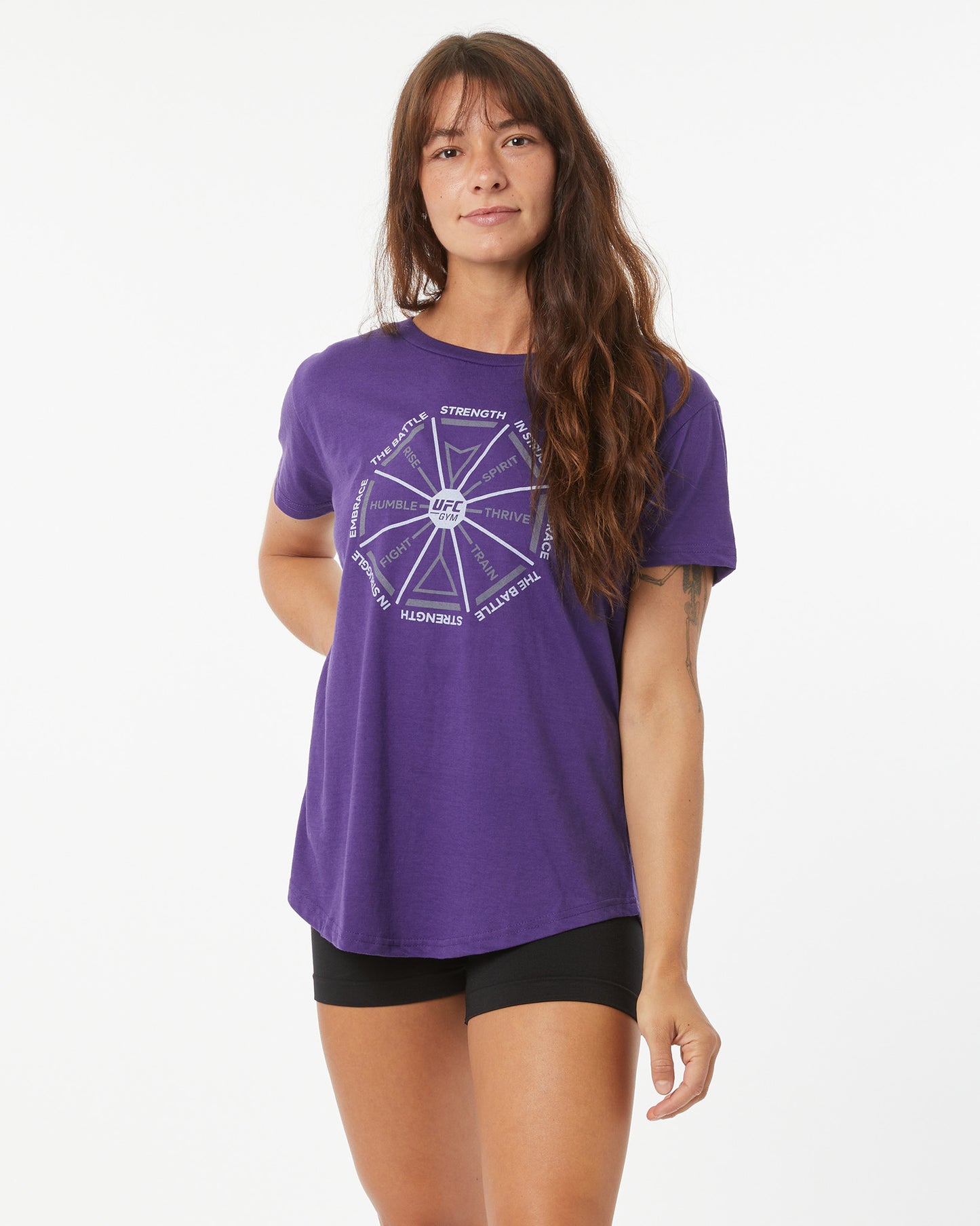 Woman wearing a purple t-shirt with a graphic design on a white background