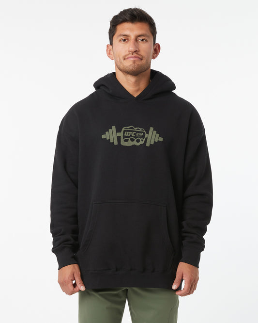 Man wearing a black hoodie with a logo on a white background
