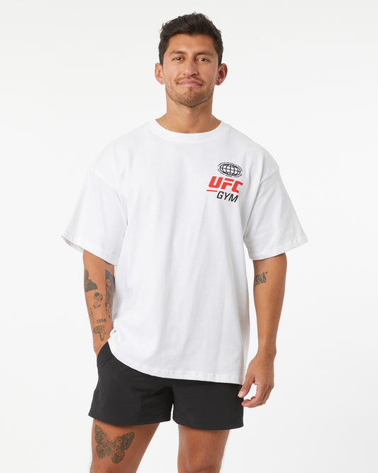 Man wearing a white UFC Gym t-shirt on a white background