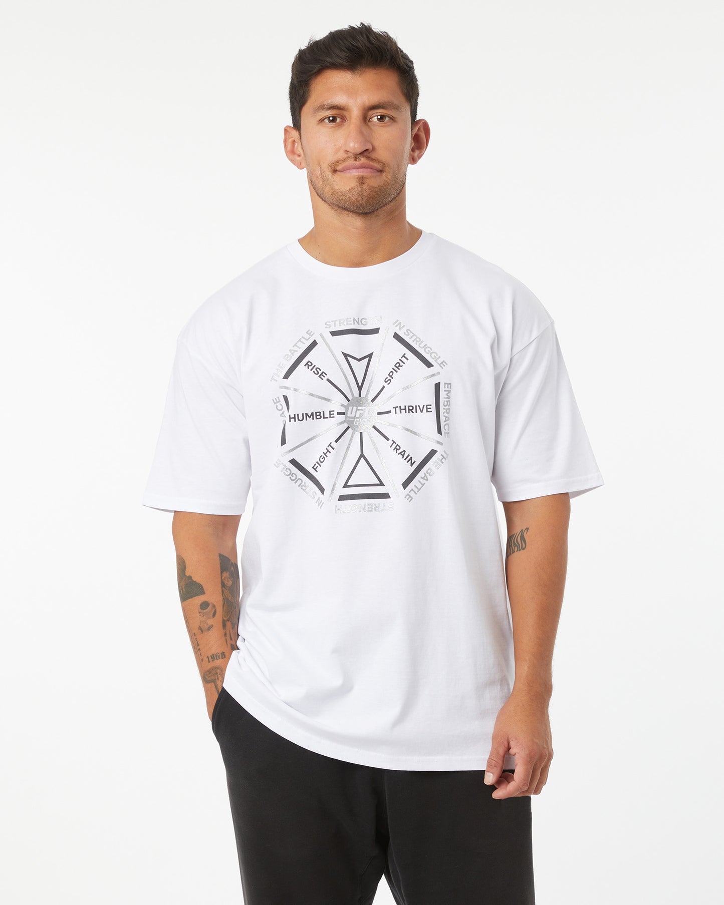 Man wearing a white t-shirt with a black graphic design on a white background