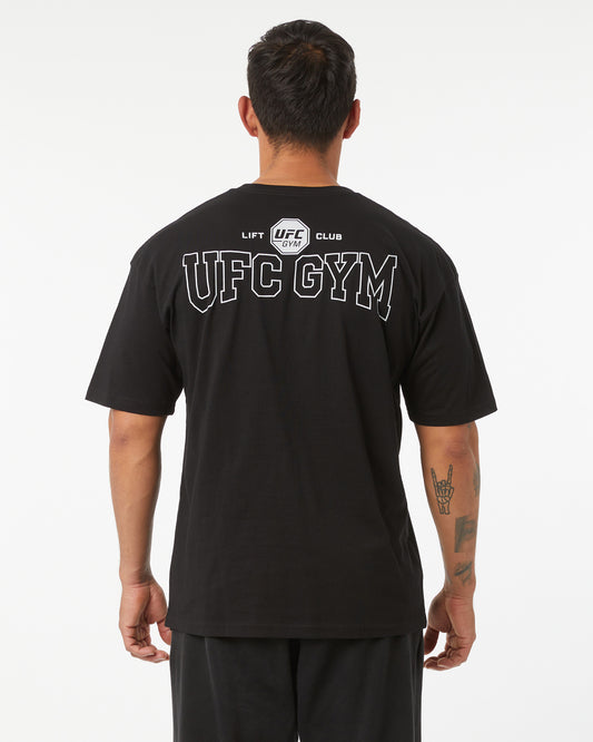Person wearing a black UFC Gym t-shirt with branding on the back.