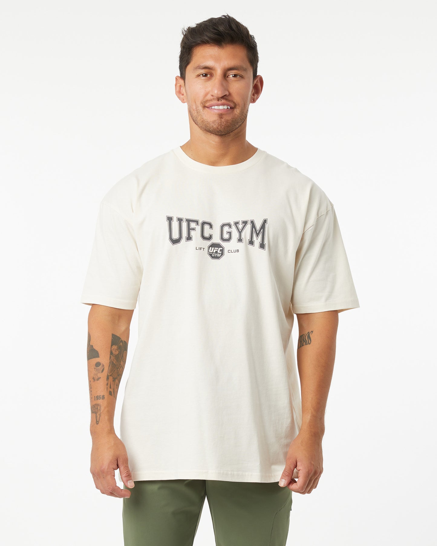 Man wearing a white UFC Gym t-shirt on a white background