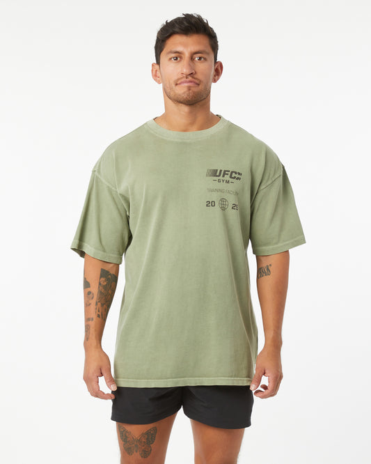 Man wearing a green t-shirt with UFC branding on a white background