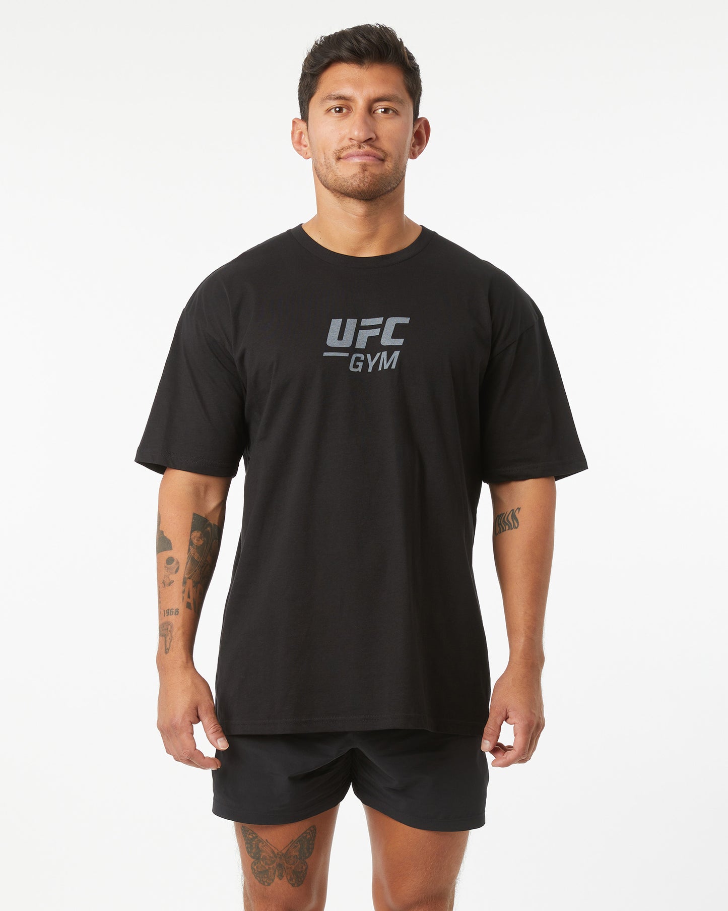 Man wearing a black UFC Gym t-shirt on a white background