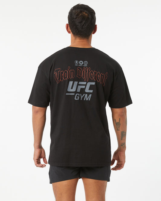 Person wearing a black UFC Gym t-shirt with branding on the back.