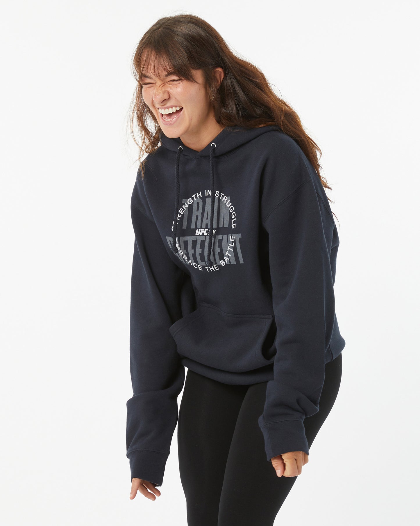 Person wearing a navy hoodie with text on a white background laughing