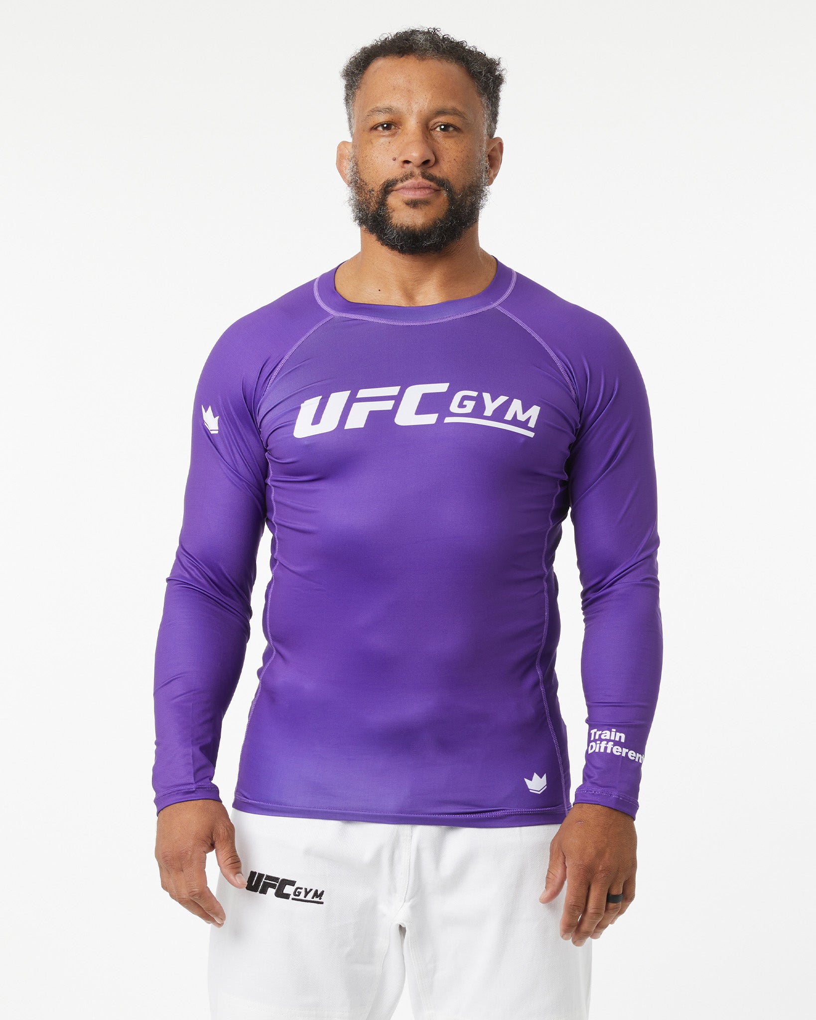 Man wearing a purple UFC Gym long-sleeve shirt on a white background
