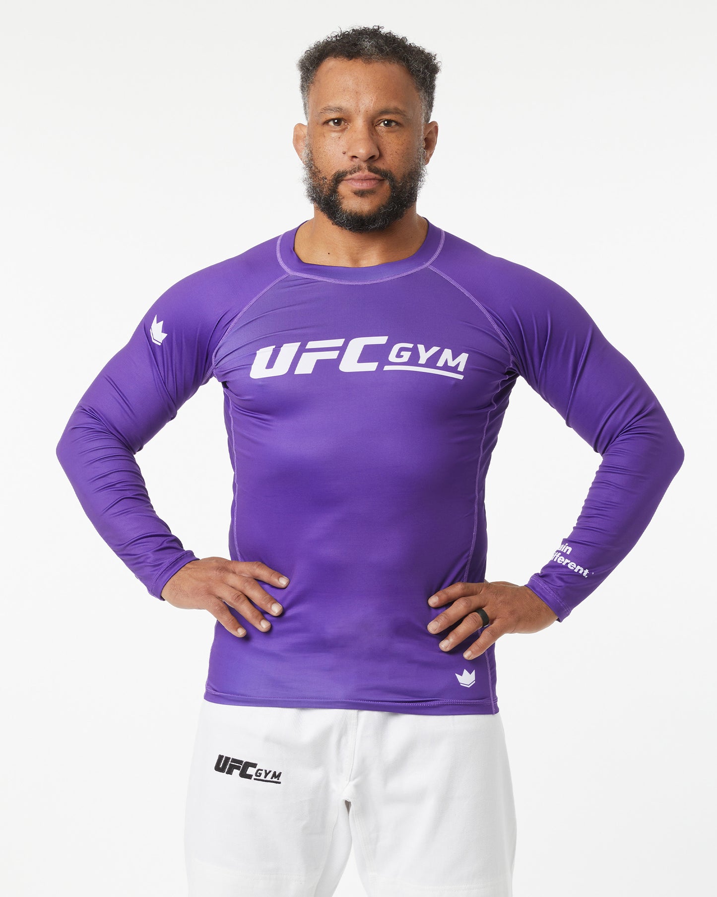Man wearing a purple UFC Gym long-sleeve shirt on a white background