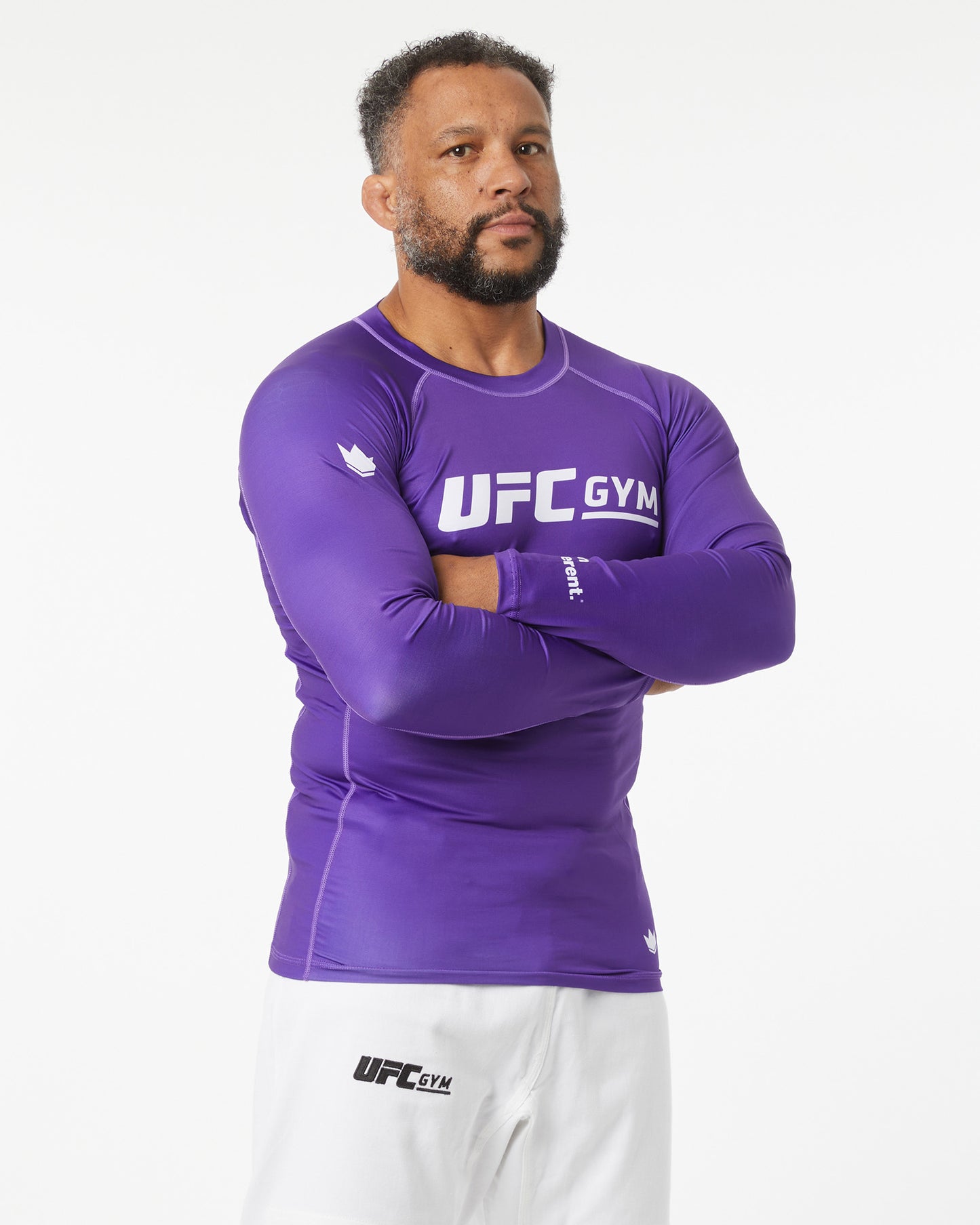 Man wearing a purple UFC Gym long-sleeve shirt on a white background