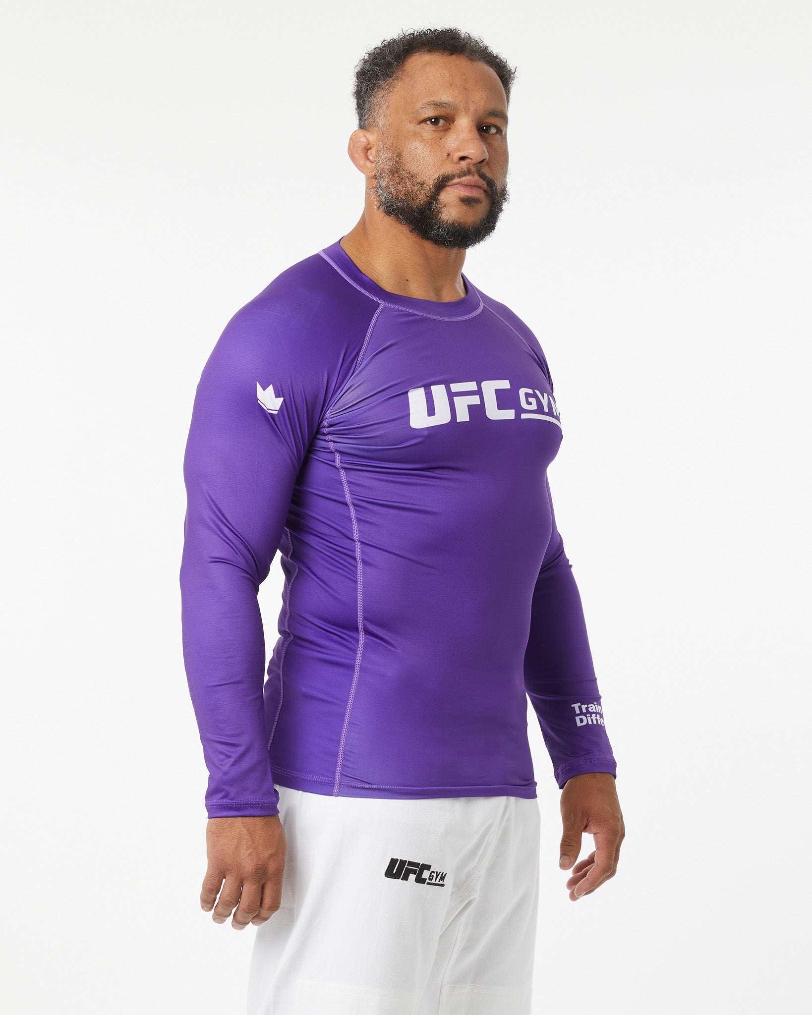Man wearing a purple UFC Gym long-sleeve shirt on a white background