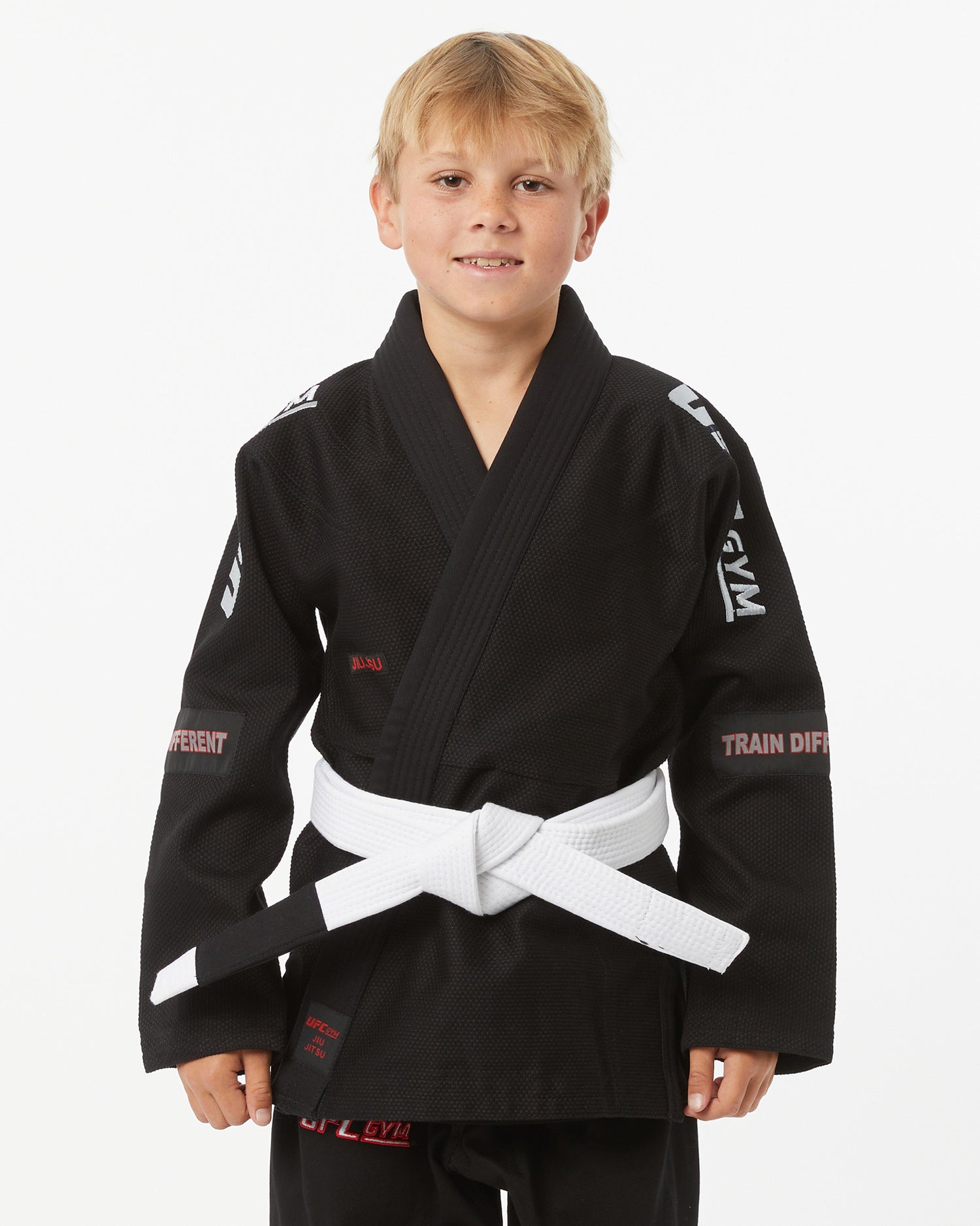 Child wearing a black UFC Gym gi with a white belt on a white background facing forward