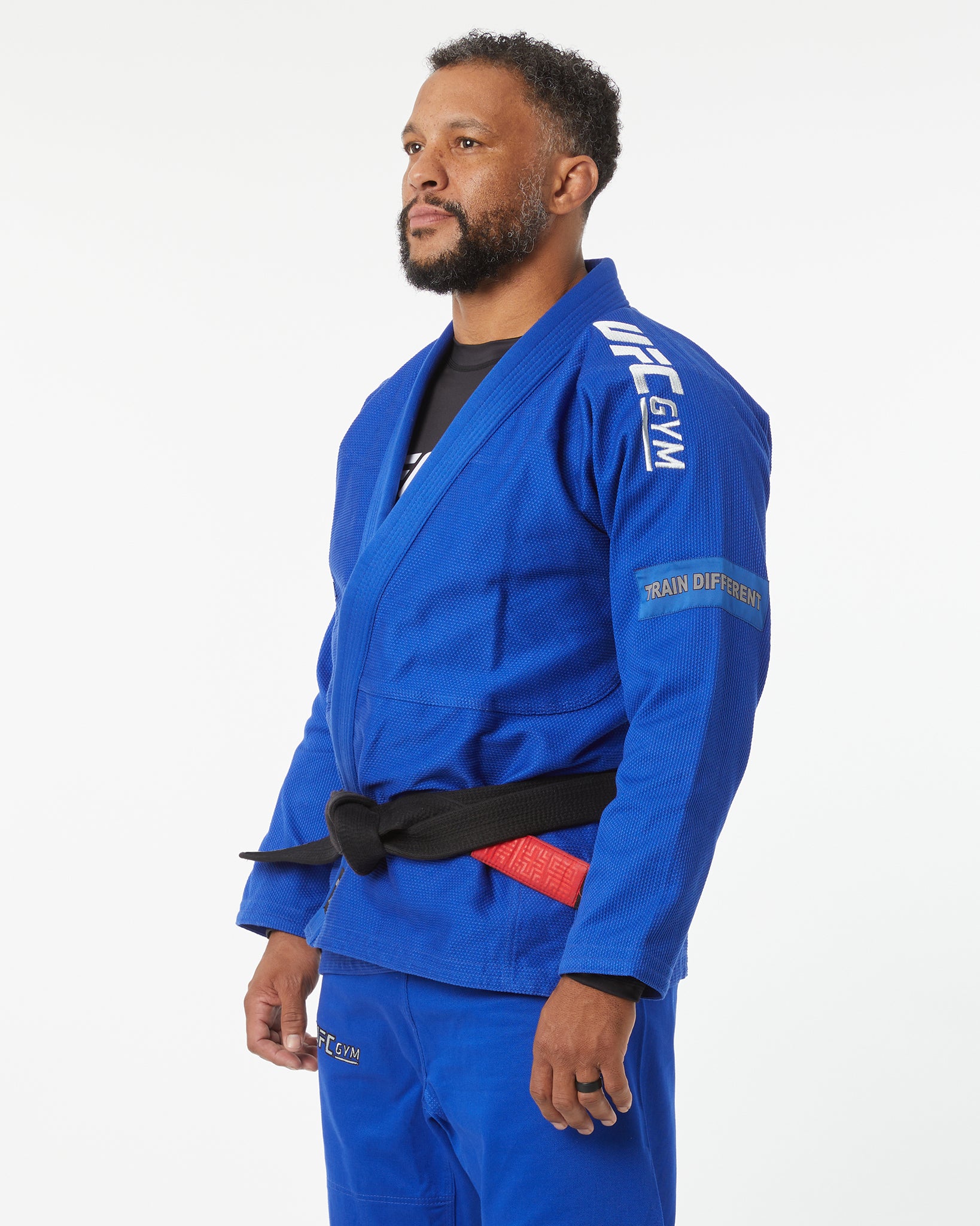 Person wearing a blue UFC gym uniform on a white background left-facing