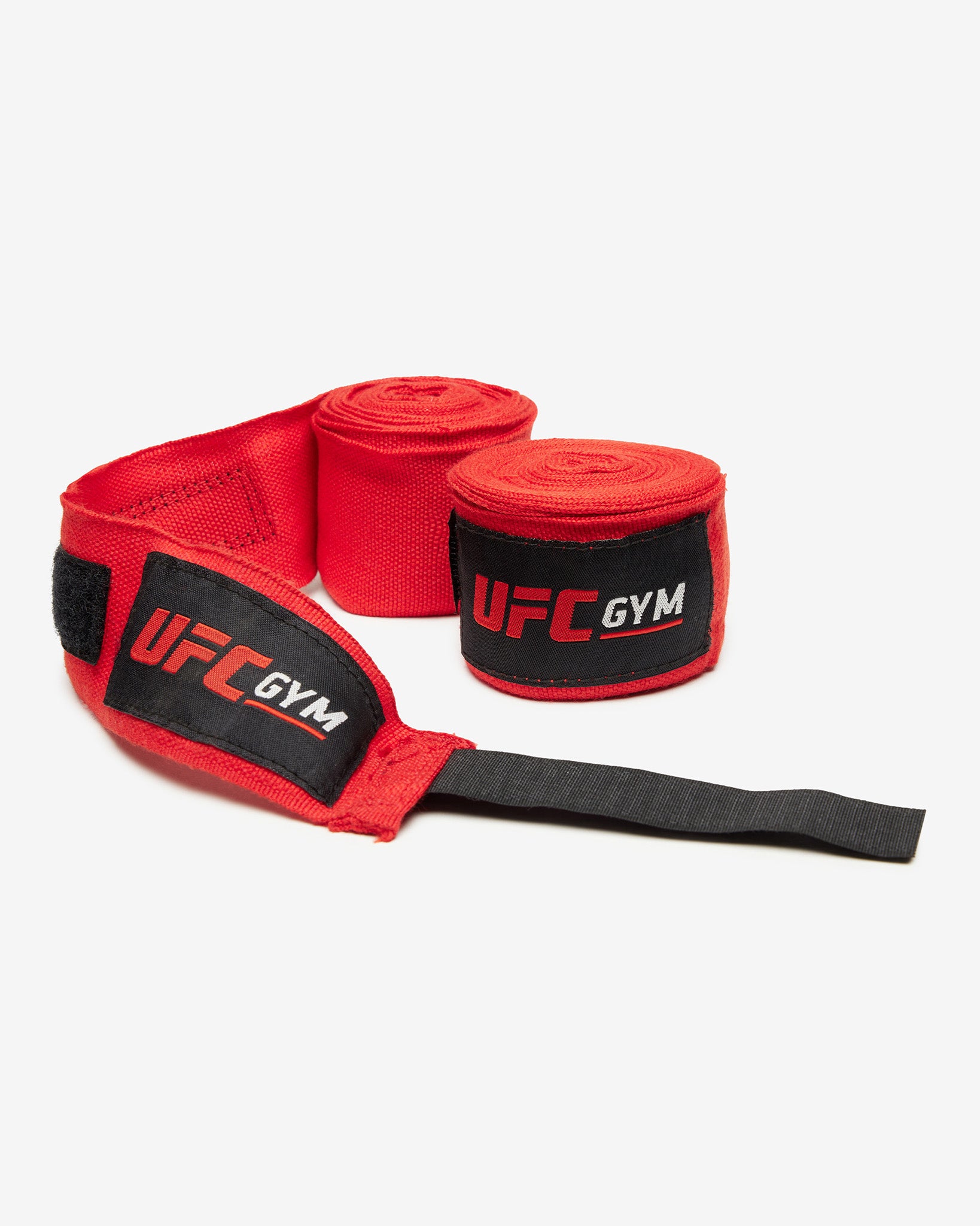 UFC Gym TD 180 HAND WRAPS RED feature black velcro straps and display the UFC Gym logo on each wrap—perfect for MMA training. Shown laid flat on a white background.