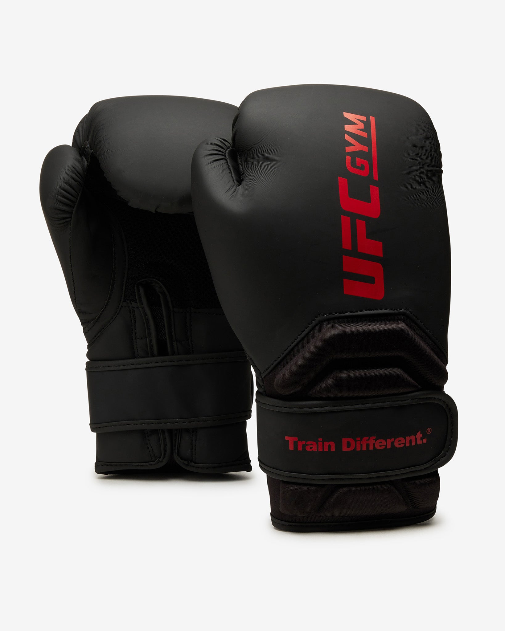 Two black TD ADULT BOXING GLOVE BLACK by UFC Gym stand upright on a white background. One glove features the red UFC Gym logo and Train Different. slogan; the other shows the palm, wrist straps, and protective design.