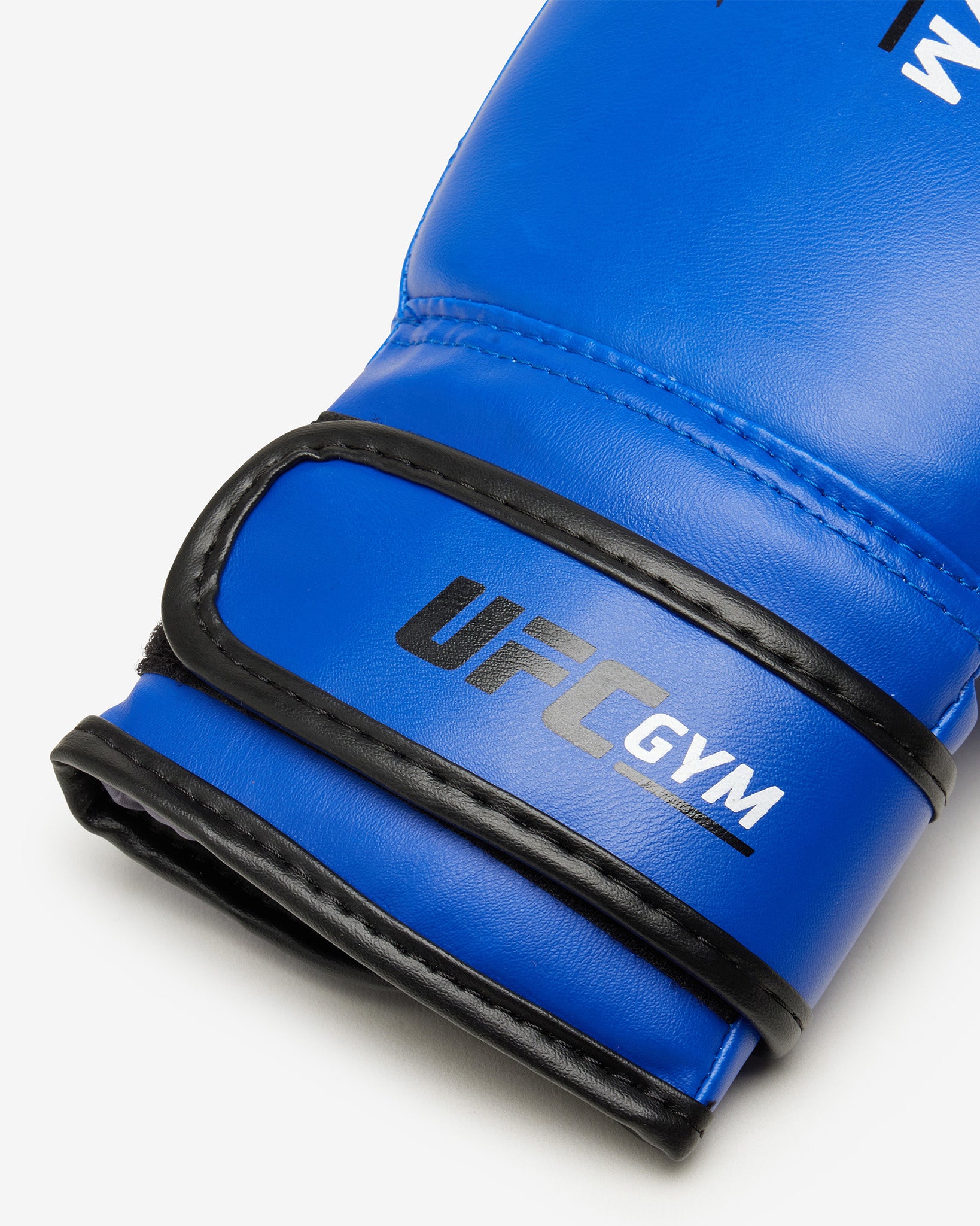 The TD YOUTH BOXING GLOVE BLUE by UFC Gym, designed for youth training, features blue gloves with black accents. Displayed on a white background
