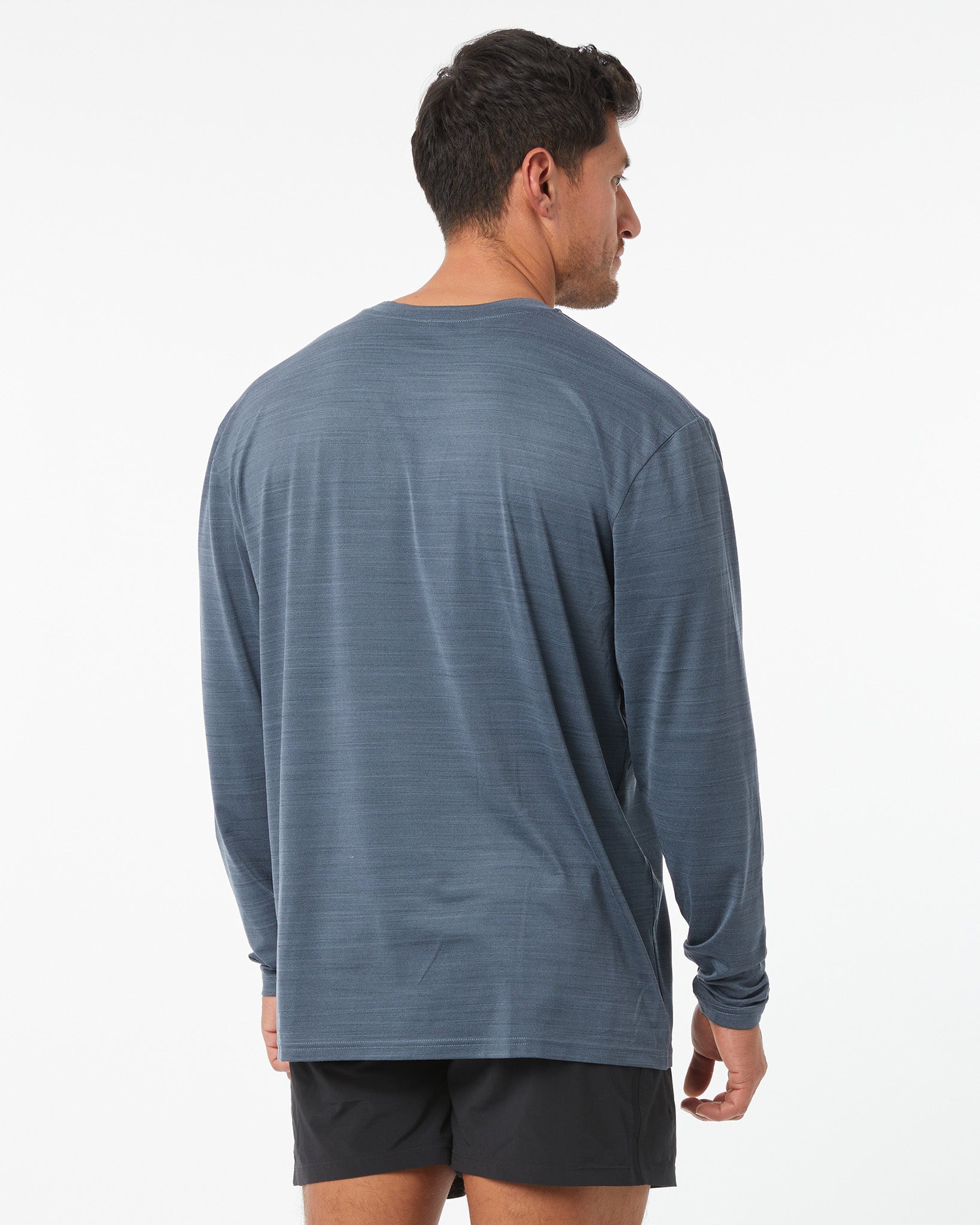 Man wearing a blue long-sleeve shirt on a white background