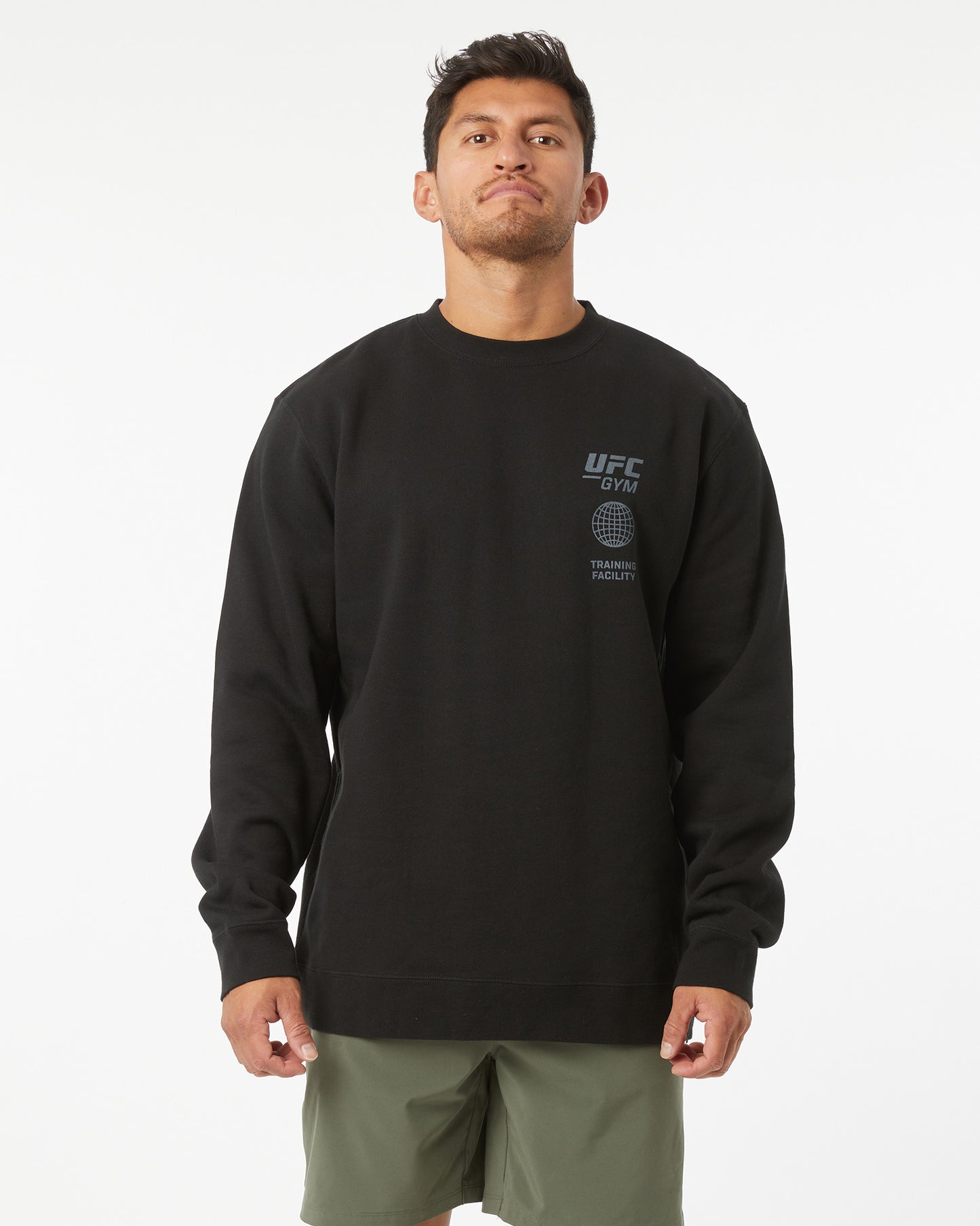 Man wearing a black UFC Gym sweatshirt on a white background