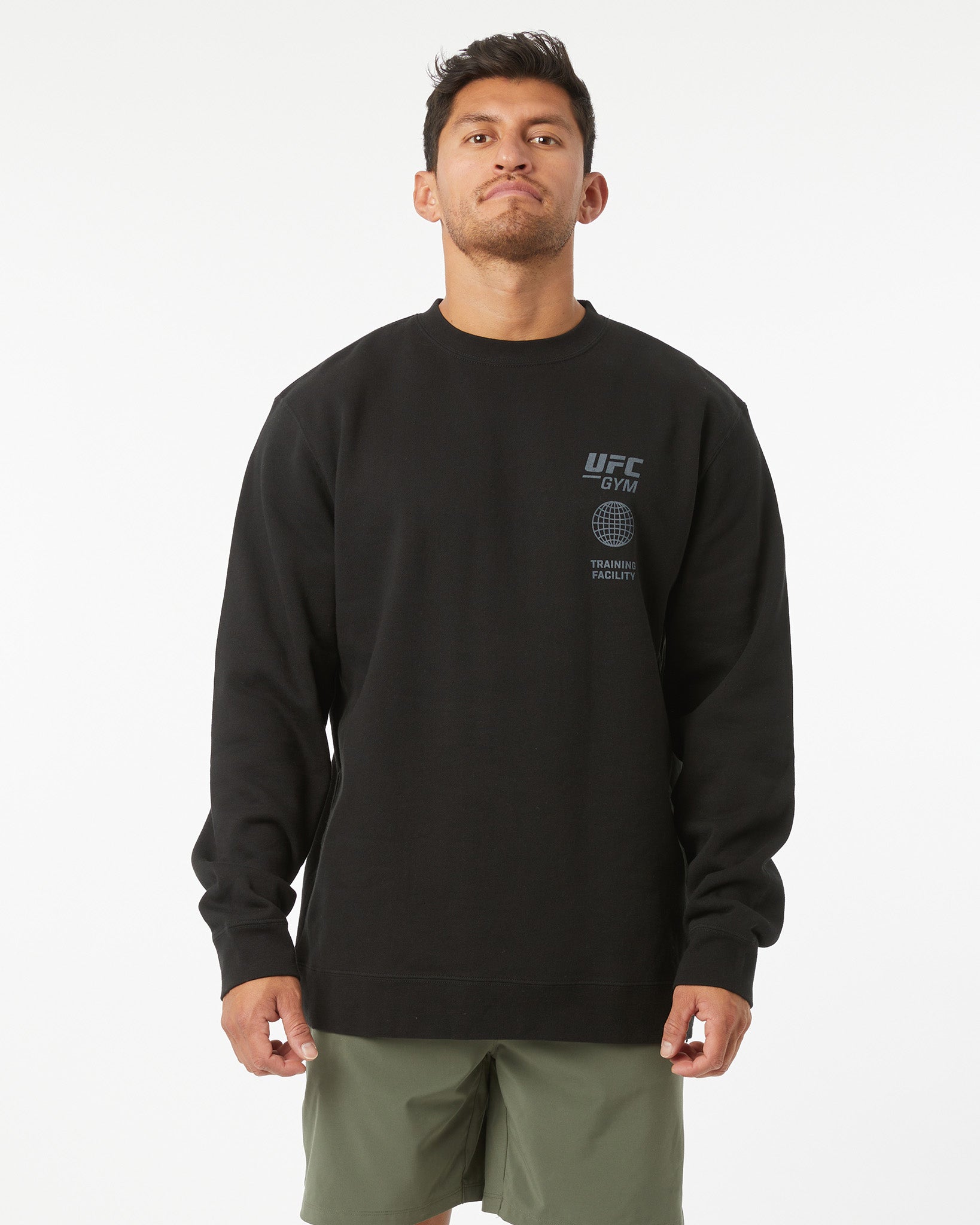 Man wearing a black UFC Gym sweatshirt on a white background