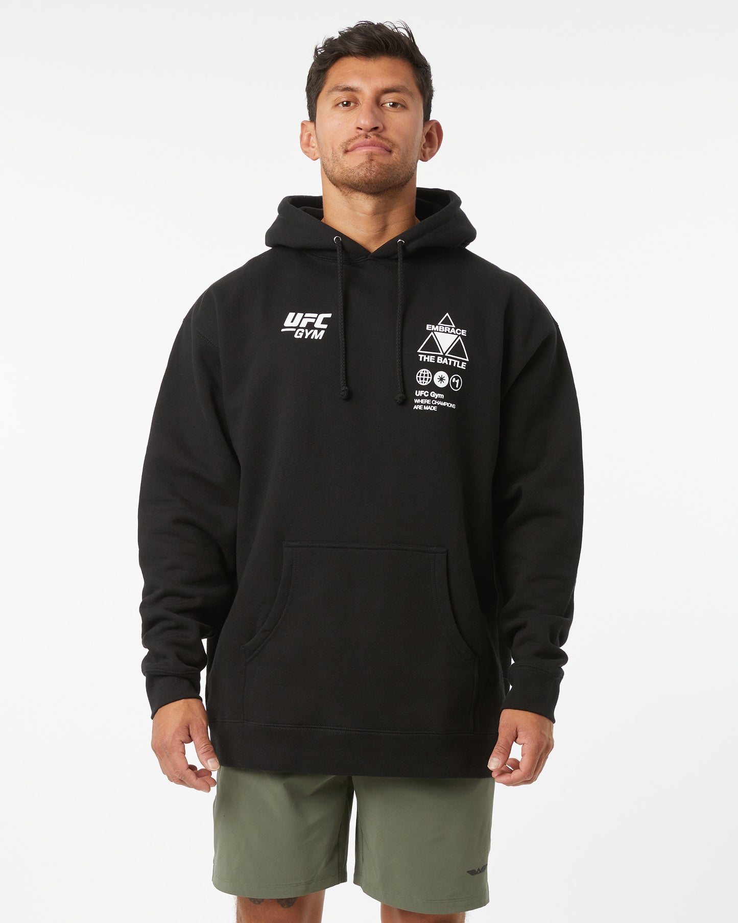 Man wearing a black UFC hoodie on a white background facing forward